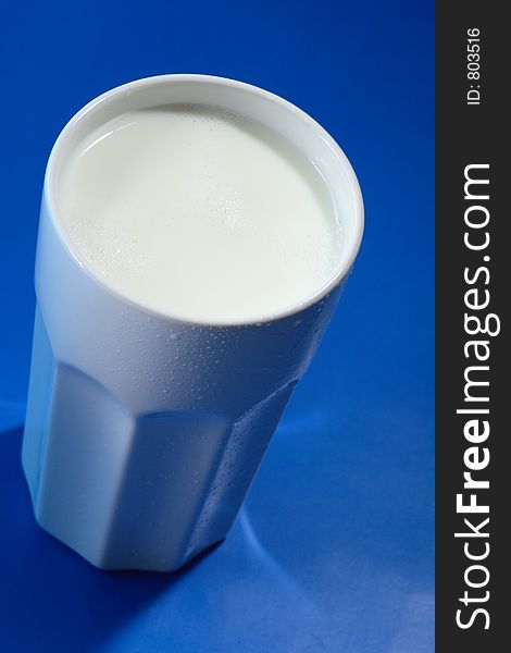 A white drugstore mug with fresh milk. A white drugstore mug with fresh milk