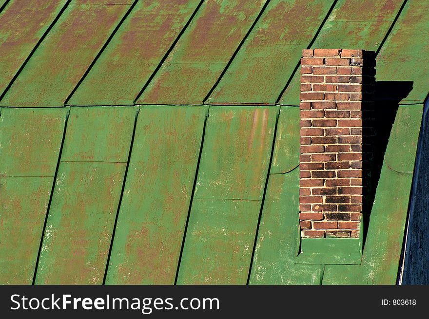 Chimney on green barn roof, horizontal. Abstract.