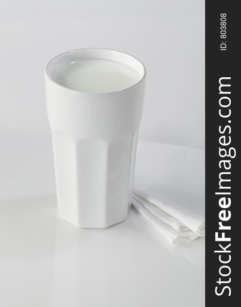 A white drugstore mug with fresh milk. A white drugstore mug with fresh milk