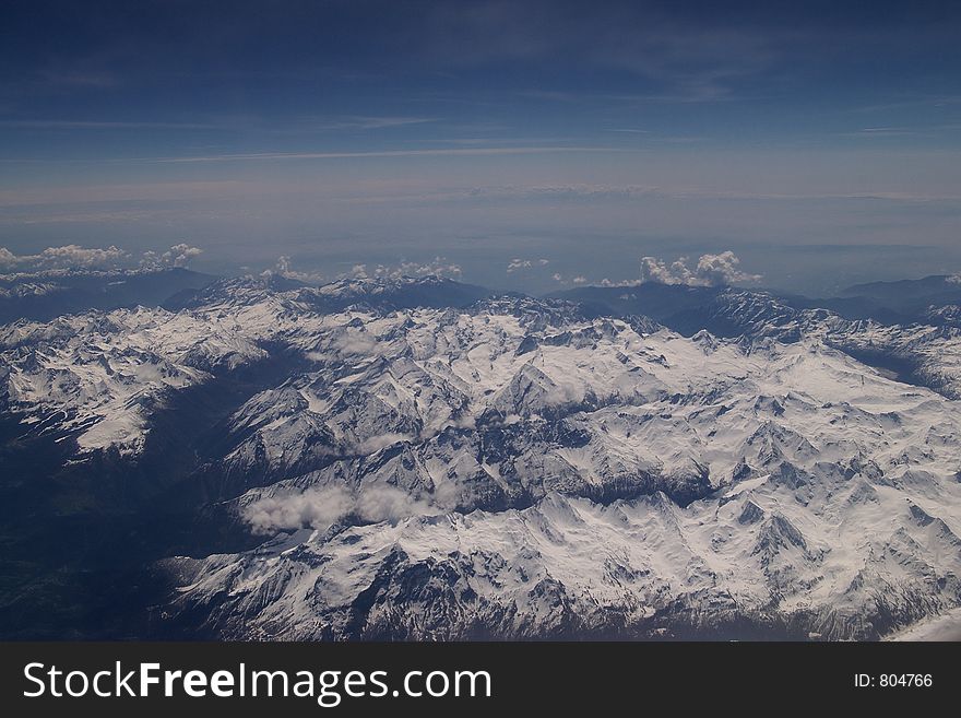 Windowseat view of the Alps mountains in Europe from 30.000 feet. Windowseat view of the Alps mountains in Europe from 30.000 feet.