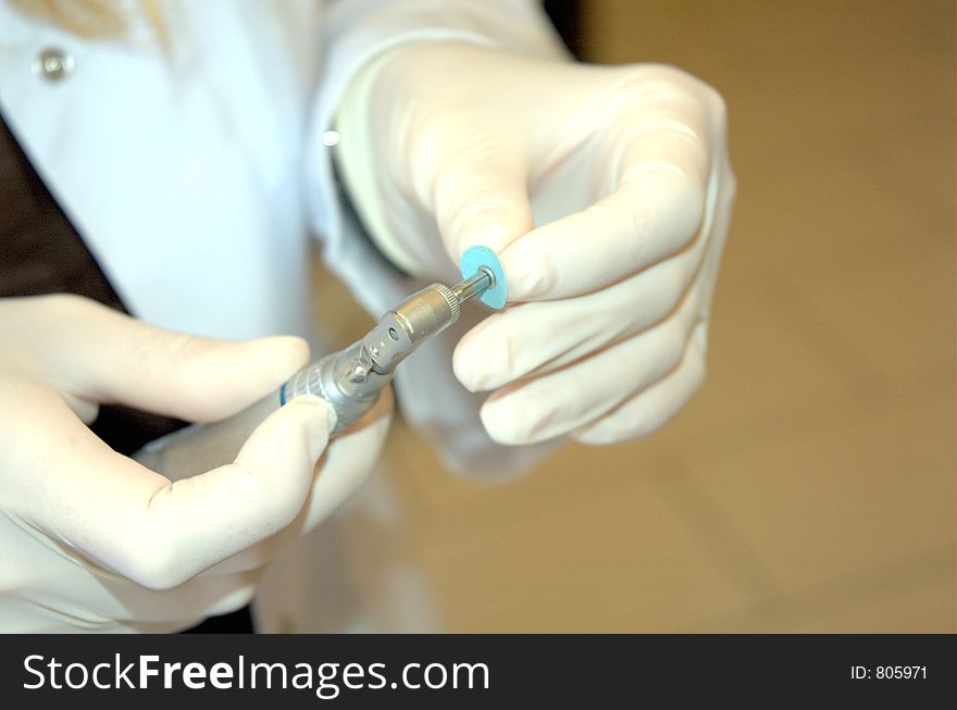 Dentist preparing emery. Dentist preparing emery