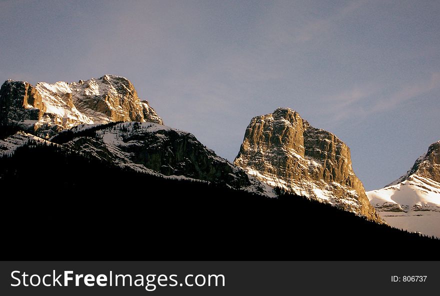 Famous landmark in Canmore, the Three Sisters wrapped in tones of dusk. Famous landmark in Canmore, the Three Sisters wrapped in tones of dusk