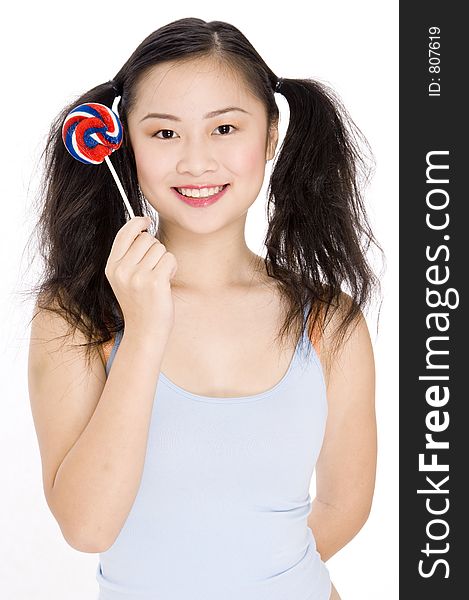 A young asian woman holidng a lollipop. A young asian woman holidng a lollipop