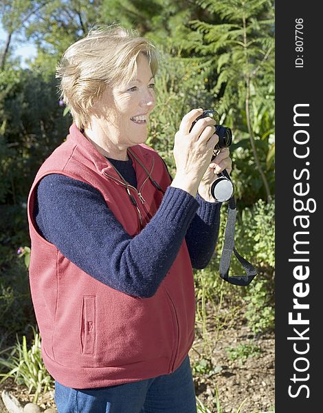 Lady taking photographs in the garden