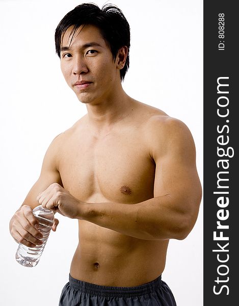 A well-built asian man holding a water bottle. A well-built asian man holding a water bottle