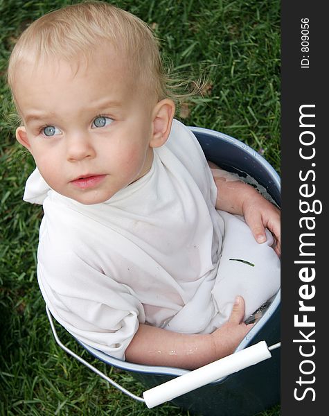 A baby in a bucket of water. A baby in a bucket of water