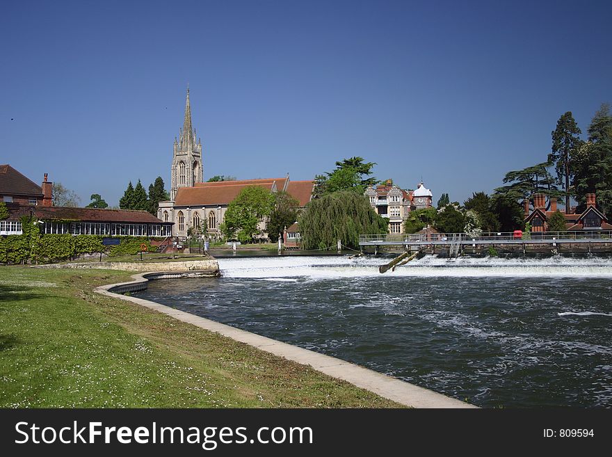 Scenic village on the river church in the background