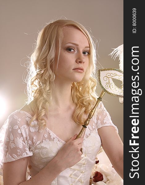 Beautiful young woman with Venetian mask, studio photo. Beautiful young woman with Venetian mask, studio photo