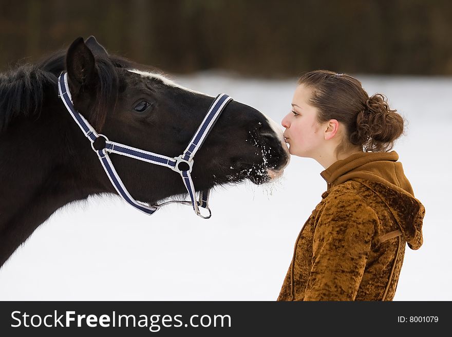 A girl kisses a horse. A girl kisses a horse