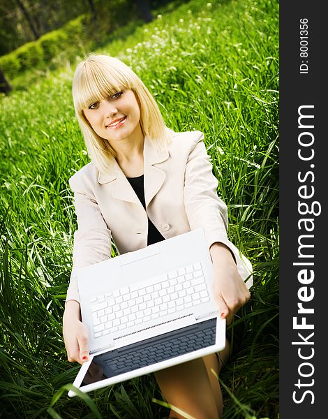 A girl with laptop outdoors. A girl with laptop outdoors