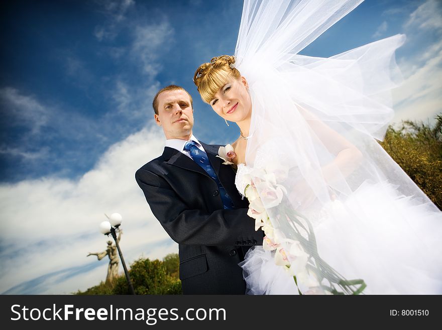 Bride With Flying Veil And Groom