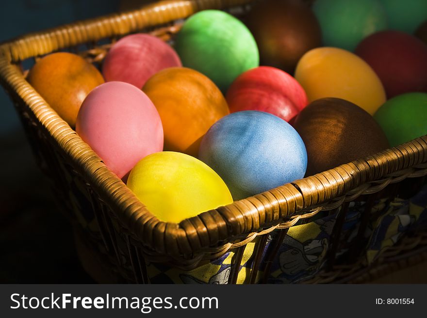 Many-colored Easter eggs lie at the basket