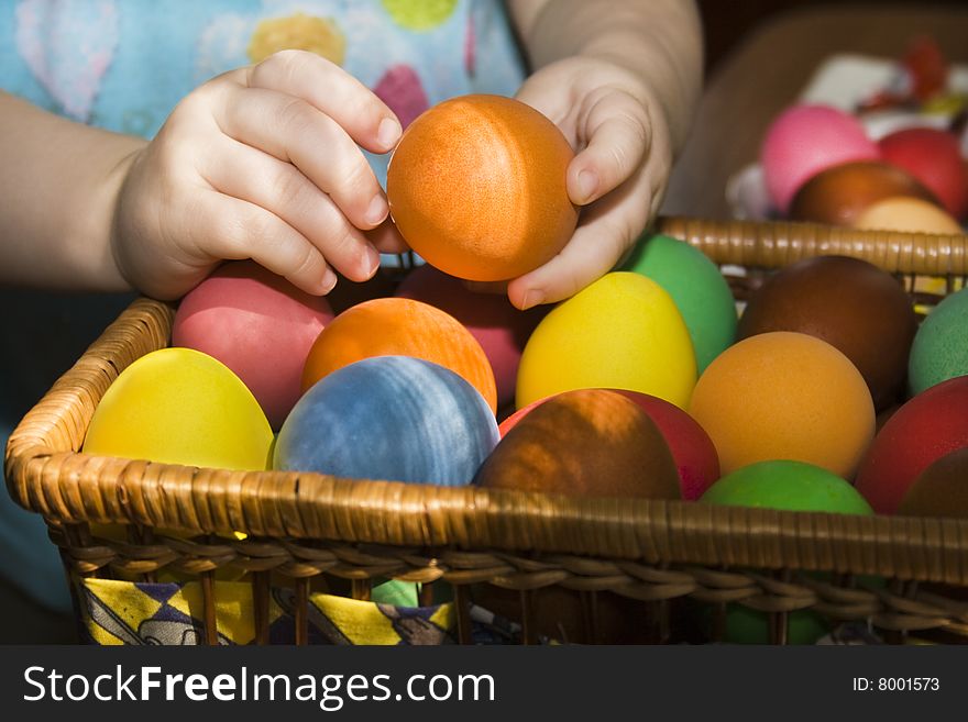 Child hands holding a multi colored egg. Child hands holding a multi colored egg.