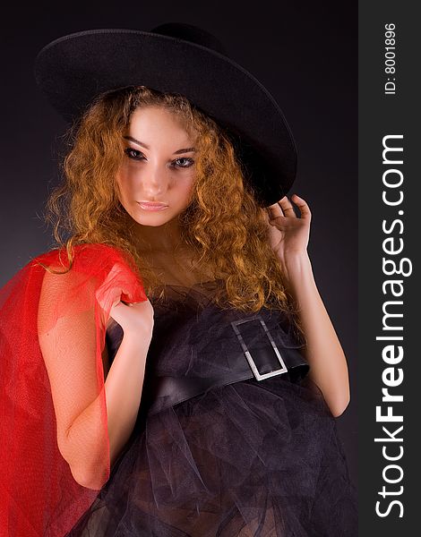 Beautiful red-haired girl in hat, studio shot