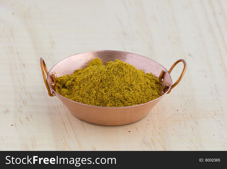 Picture of frying pan isolated in background of wood with curry. Picture of frying pan isolated in background of wood with curry