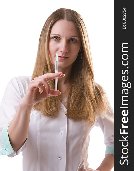 Beautiful woman in a doctor's smock with a syringe in a hand isolated on a white background