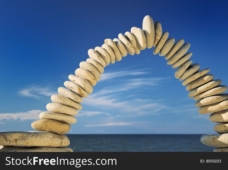 Sea pebble combined in an arch against the sky. Sea pebble combined in an arch against the sky