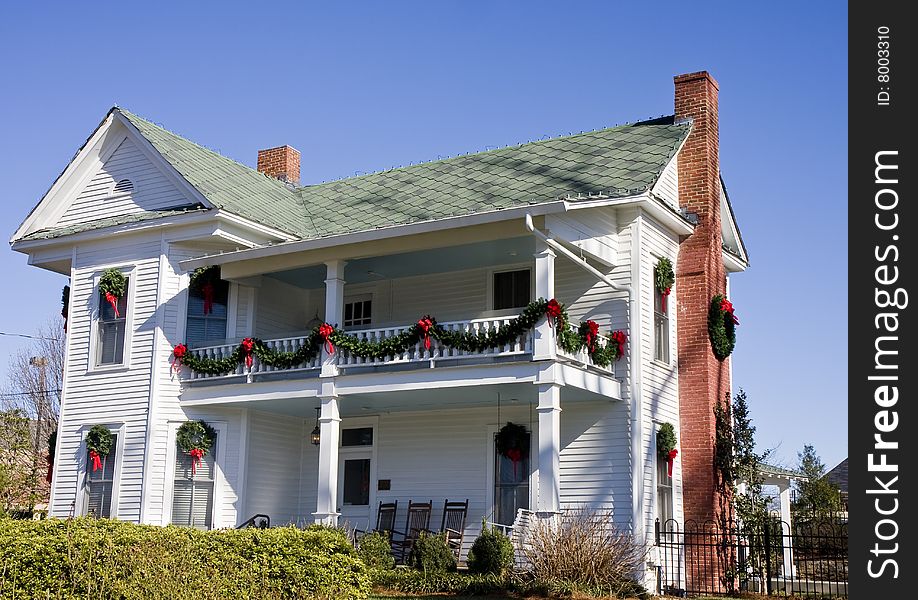 An old white farm house decorated for Christmas. An old white farm house decorated for Christmas