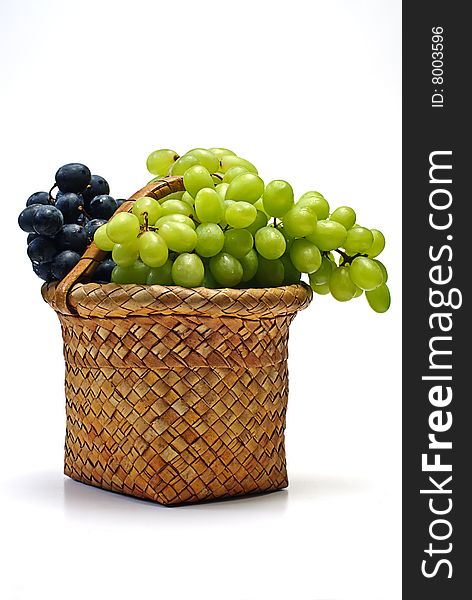 Grape in wooden basket on white