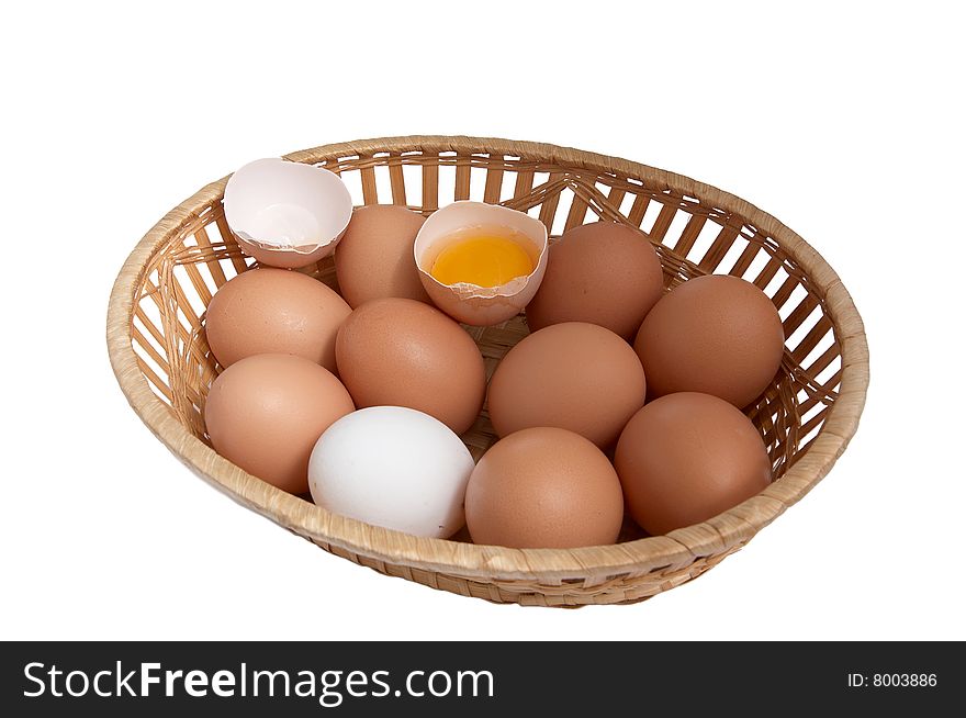 Chicken eggs in the brown basket.