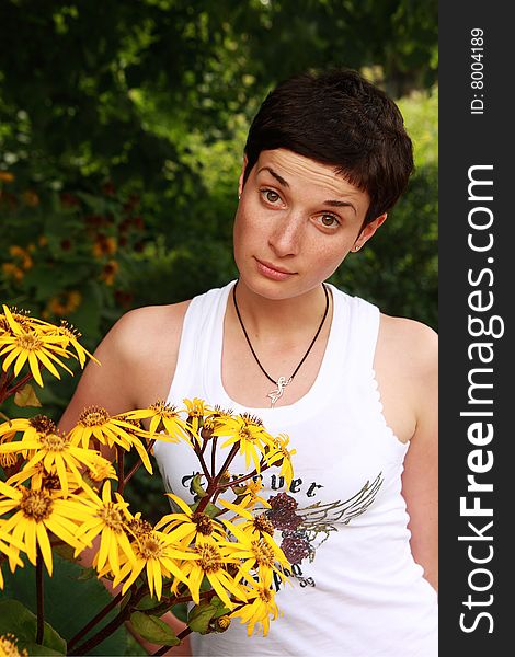 Portrait of an attractive girl with yellow flowers