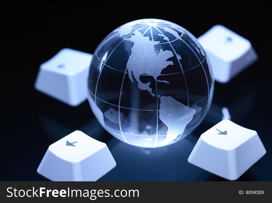 Nice glassy globe on dark background with computer's keys. Nice glassy globe on dark background with computer's keys