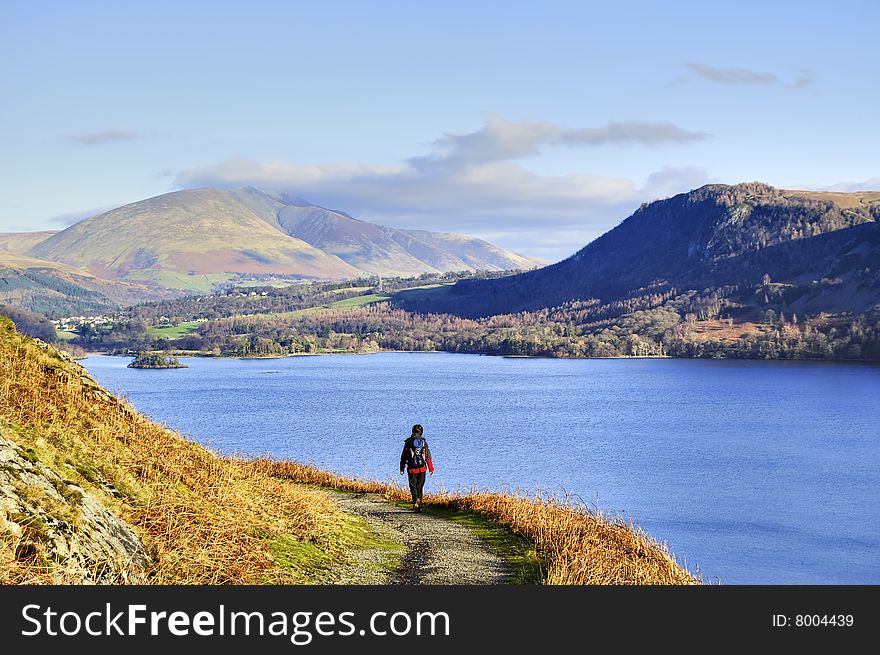 A Female hiker with Derwent Water in the background. A Female hiker with Derwent Water in the background