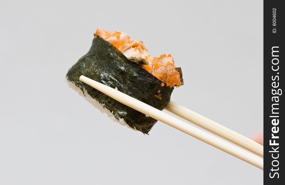 Sushi and chopsticks on the neutral background