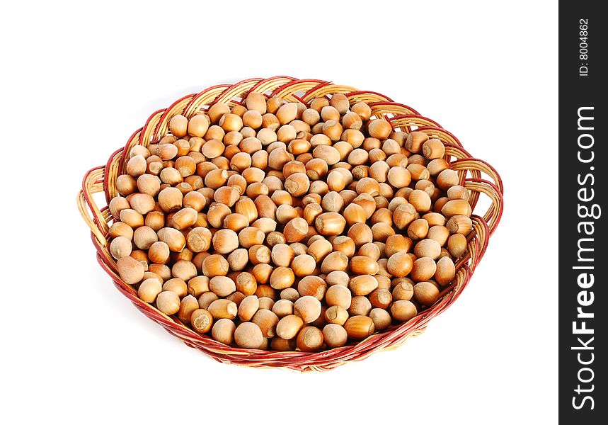 Hazelnuts in a basket on a white background