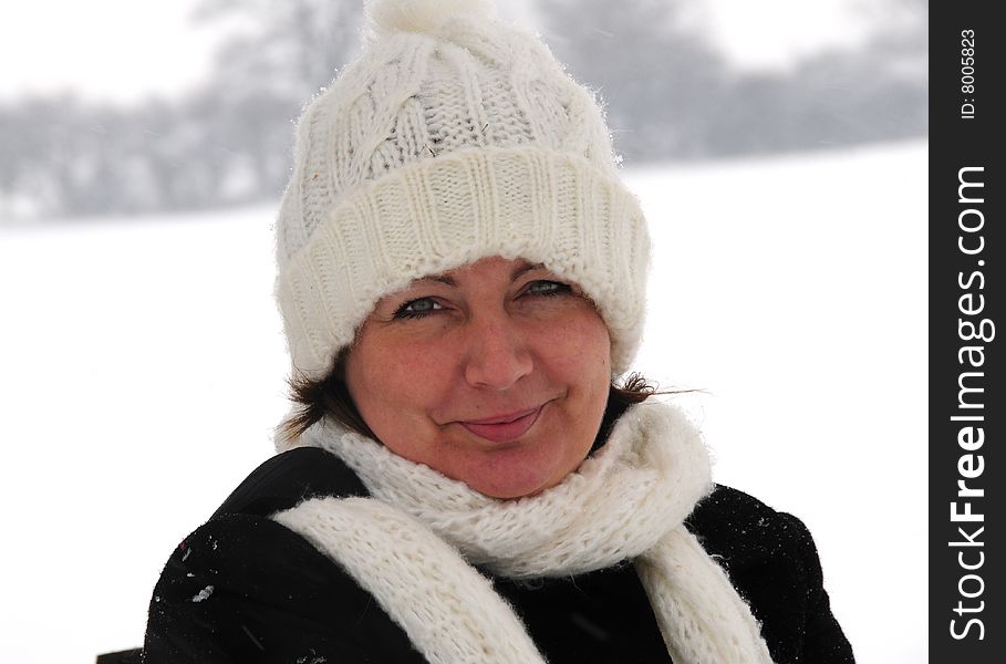 Shot of a woman in her hat and scarf on a snowy day. Shot of a woman in her hat and scarf on a snowy day
