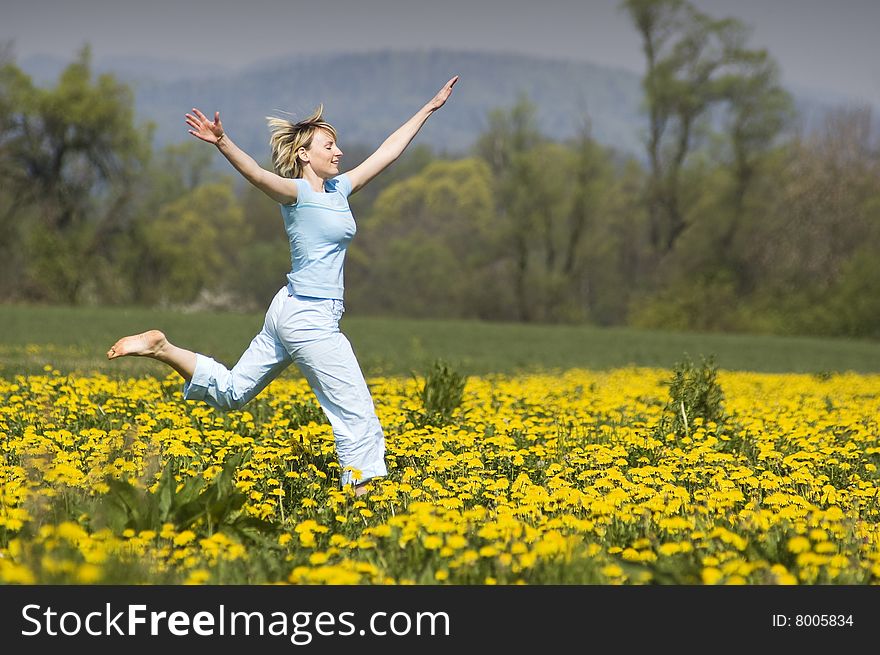 Young blond happy woman running on grass. Young blond happy woman running on grass