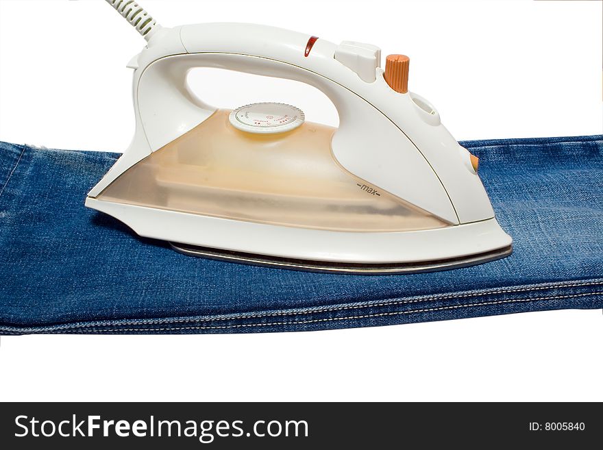 Electric iron on jeans. An isolated white background