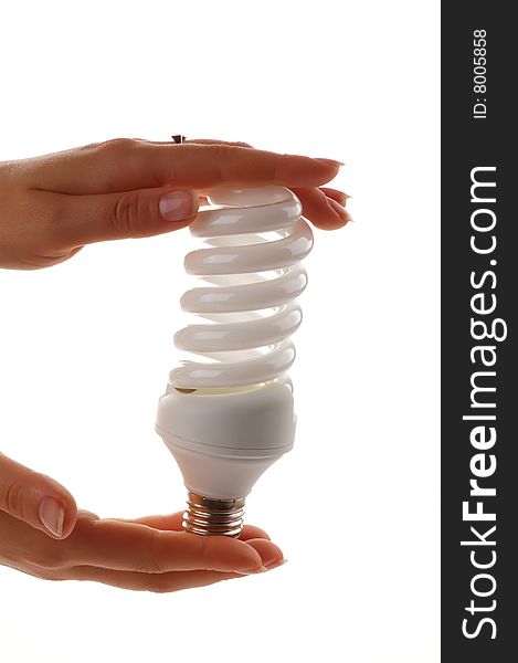Energy saver lamp in the hands on white background