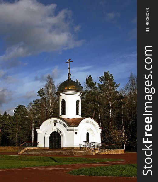 A white chapel on a forest background