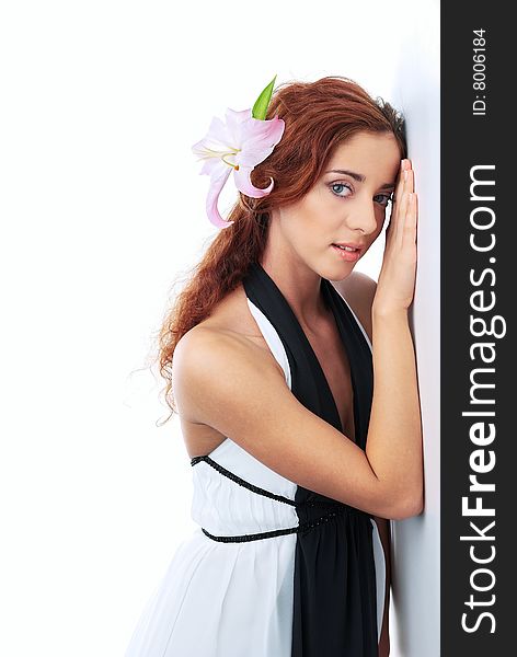 The red-haired girl in a white dress on a white background