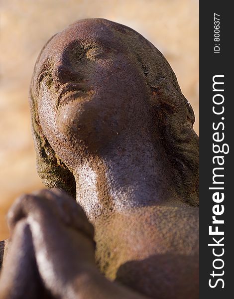 Statue of a Rusty iron woman praying