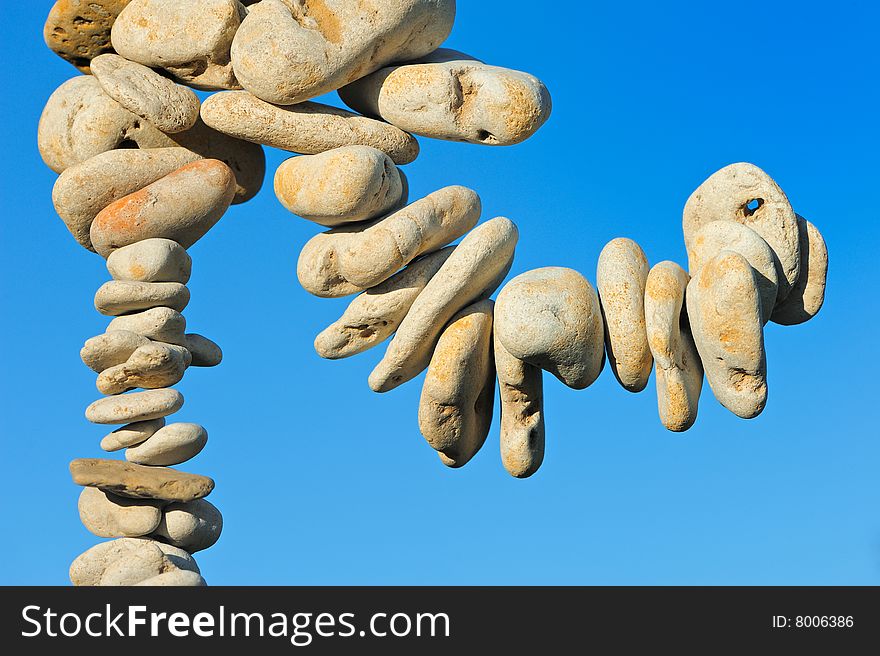 Sea pebble collected in a chain against the sky. Sea pebble collected in a chain against the sky