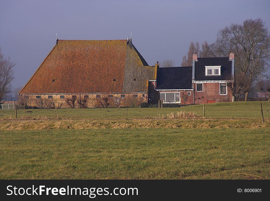 Ancient Frisian farmhouse with a huge barn. Ancient Frisian farmhouse with a huge barn.