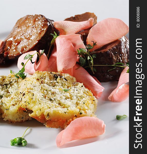 Beef Plate with Potatoes Galette Served with Boiled Rose Petal and Wine Sauce. Isolated on White Background