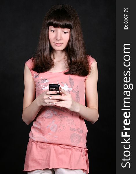 Girl standing in studio with a phone. Girl standing in studio with a phone