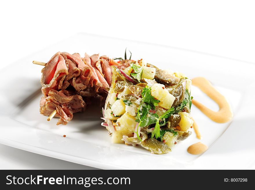 Roast Beef Served with Salad (Potatoes and Vegetables) and Cherry Tomato. Isolated on White Background