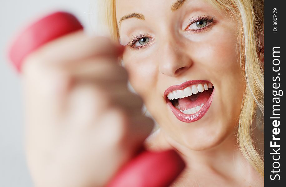 Attractive young woman excercising against a white background. Attractive young woman excercising against a white background.