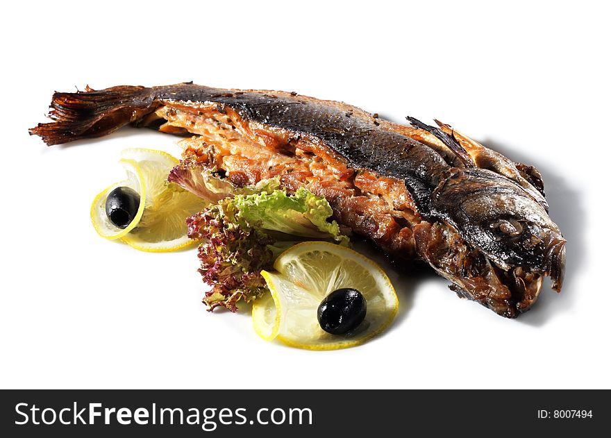 Fish Baked in Spicy Served with Salad Leaves, Lemon and Olives. Isolated on White Background. Fish Baked in Spicy Served with Salad Leaves, Lemon and Olives. Isolated on White Background