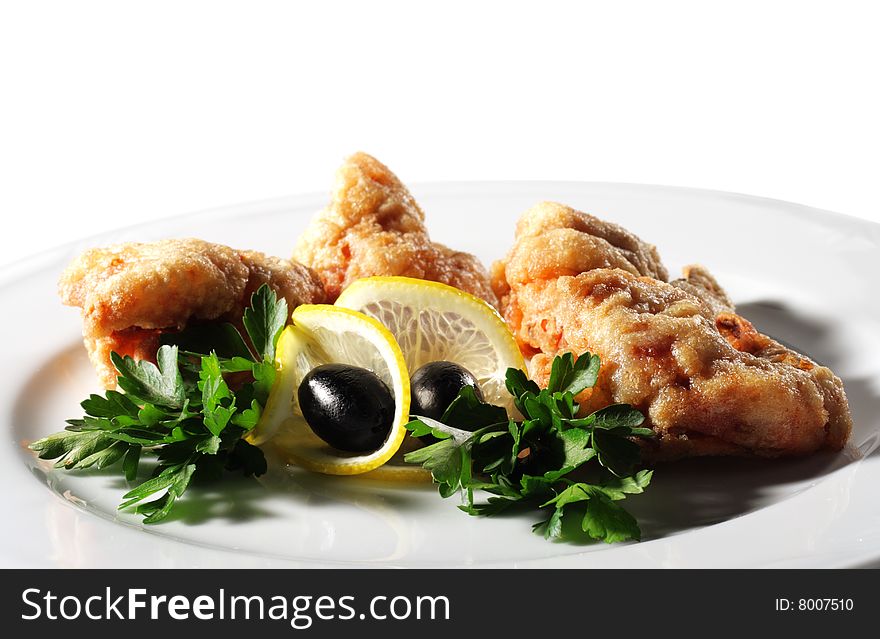 Seafood - Deep-Fried Shrimps in Bacon Dressed with Parsley, Olives and Lemon. Isolated on White Background