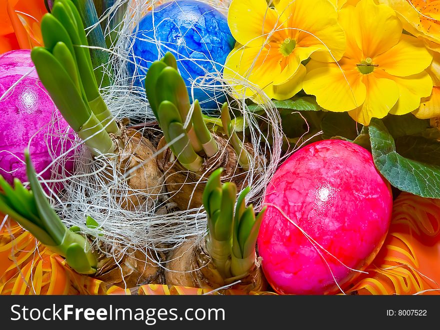 Easter eggs in a basket with flowers