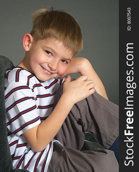 Smiling boy on gray background