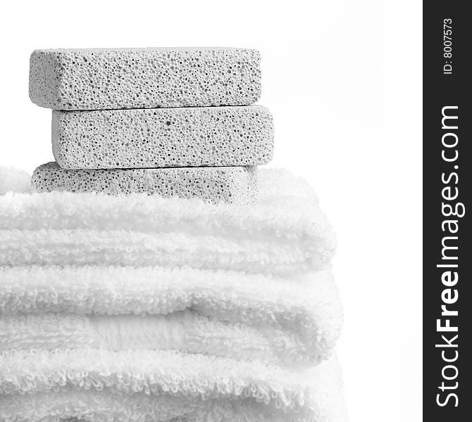 Pumice stones and towels against a white background. Pumice stones and towels against a white background.