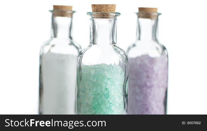Colored bath salt against a white background.