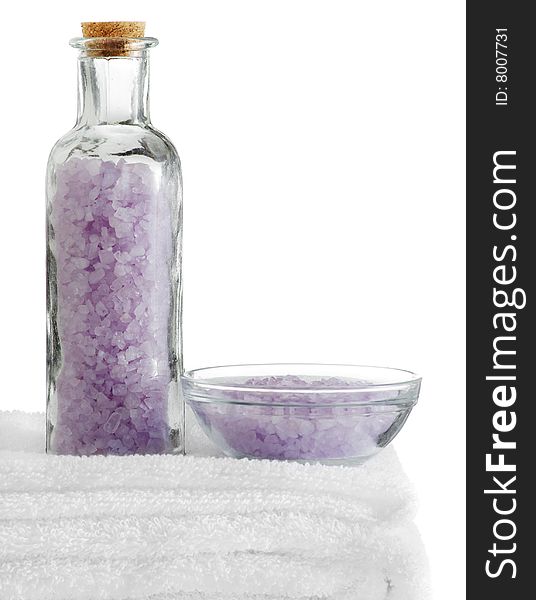 A spa scene on top of fluffy white towels against a white background.