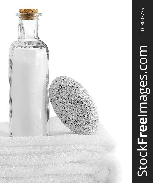 A spa scene on top of fluffy white towels against a white background.